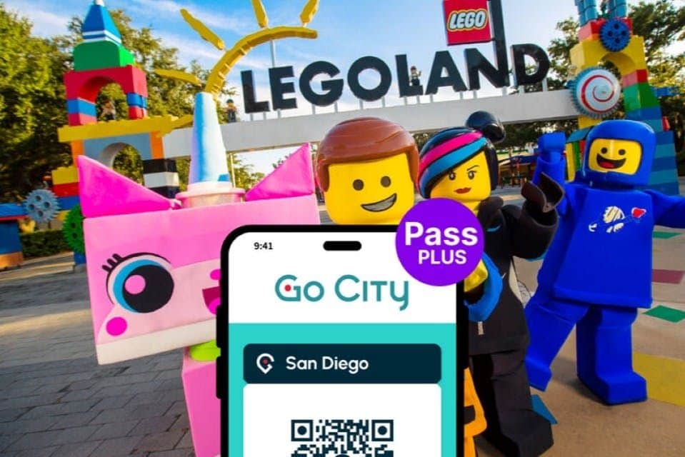 Three LEGO figures pose in front of a LEGOLAND sign, with a Go City Pass Plus for San Diego QR code shown in the foreground.