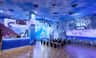 Indoor area with an Arctic theme, featuring ice decor, benches, and a counter labeled 'Ice Cream.'